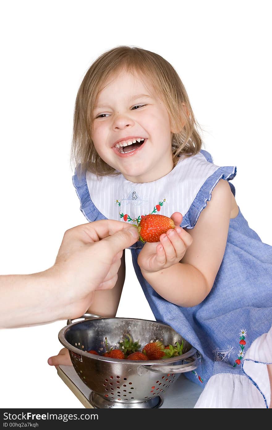 The girl eats a strawberry on an isolated background