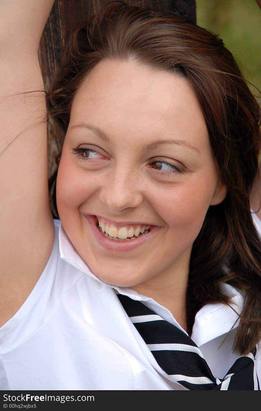 A stunning girl in shirt and tie with a happy smile. A stunning girl in shirt and tie with a happy smile.