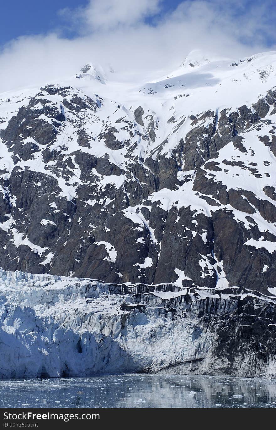 Glacier, mountains and clouds above in Glacier Bay national park, Alaska. Glacier, mountains and clouds above in Glacier Bay national park, Alaska.