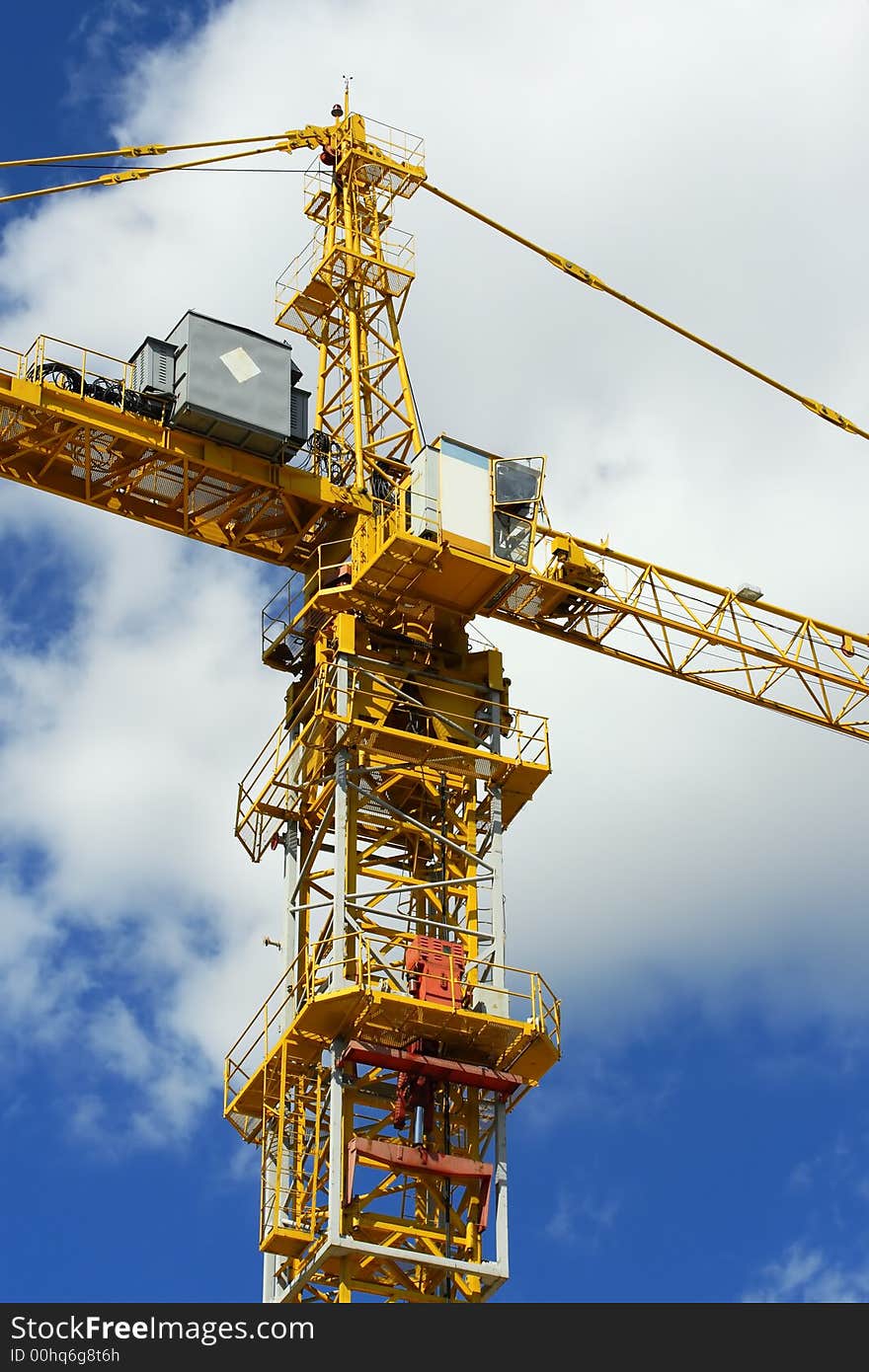 Fragment of the elevating crane on a background of the sky