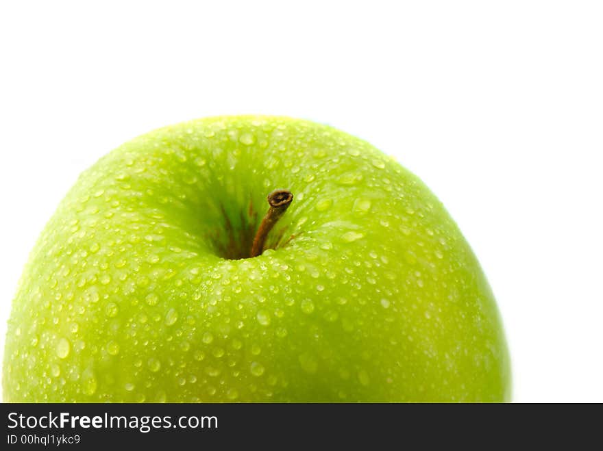 Big green apple covered  drop of water on  white background