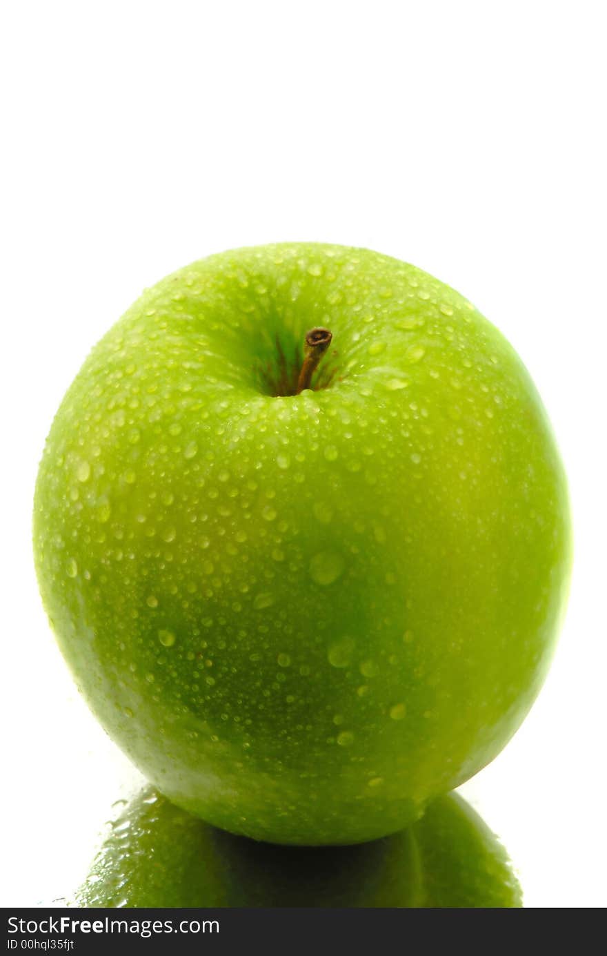 Green apple covered drop of water on white background