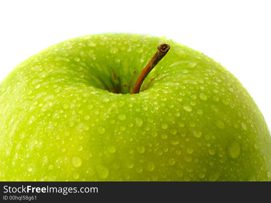 Big green apple covered  drop of water on  white background