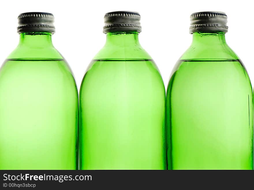 Three bottles green color with mineral water on white background