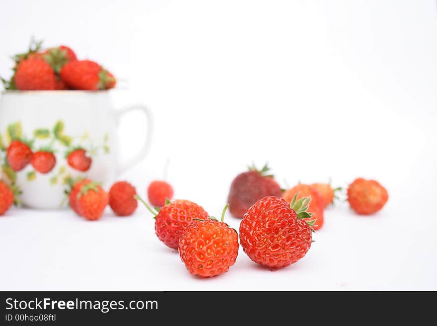 Strawberries in the small pot on white background. Strawberries in the small pot on white background