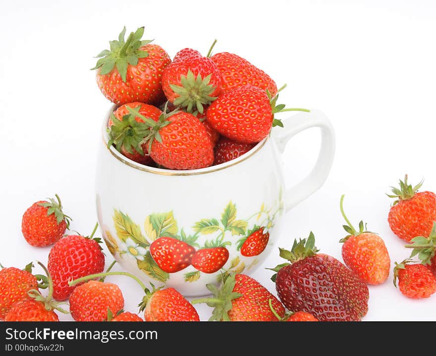 Strawberries in the small pot on white background. Strawberries in the small pot on white background