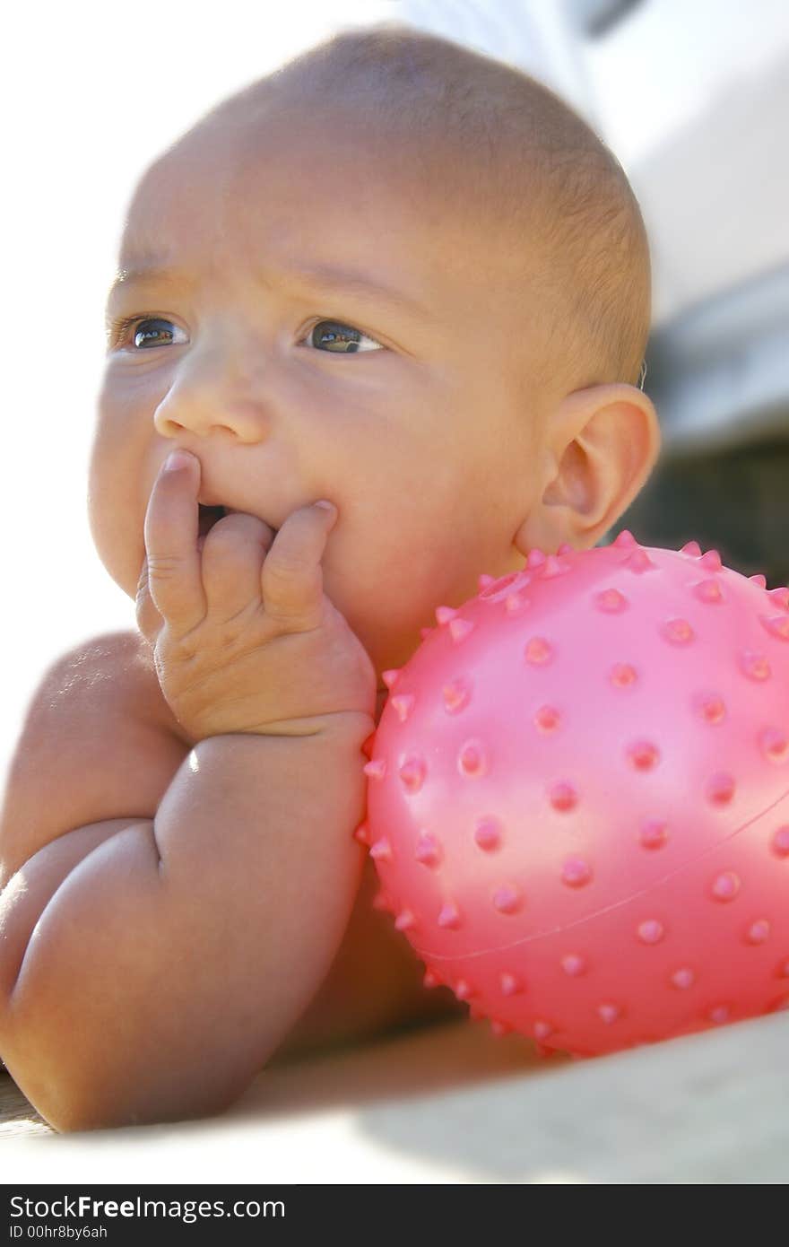 Baby boy with pink ball