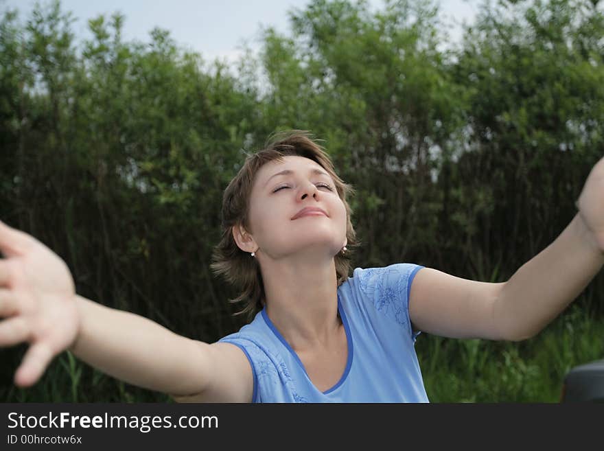 Happy girl in blue sports-jersey outdoor in summer