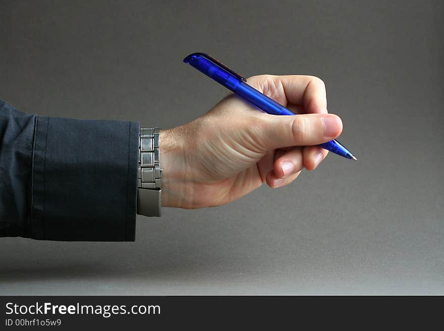 Hand with a blue pen