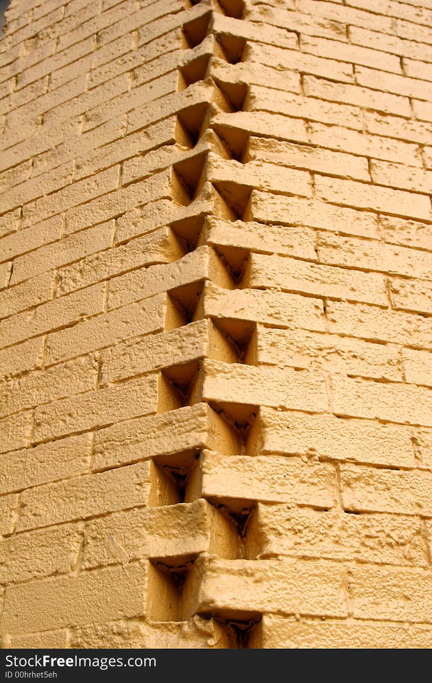 A corner between two yellow brick walls. A corner between two yellow brick walls