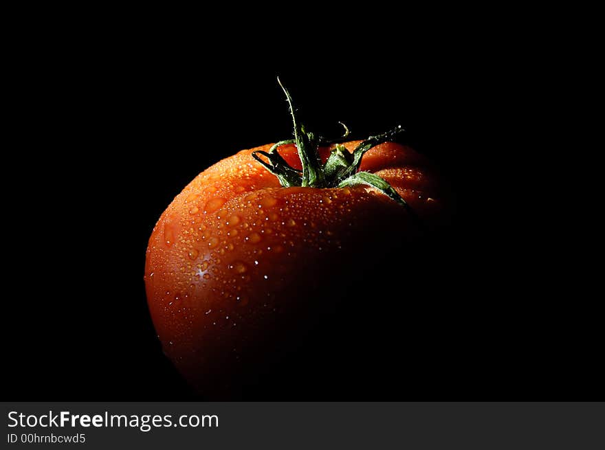 Refreshing tomato on black