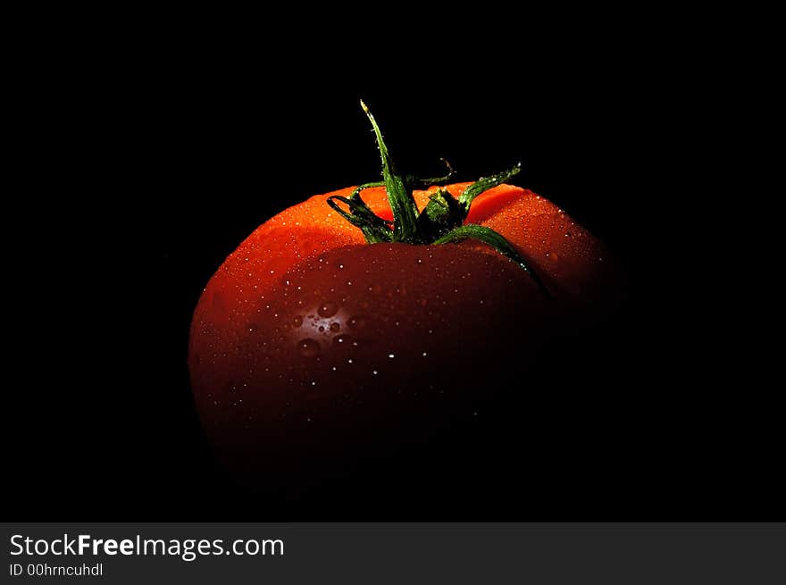 Fresh tomato with water drops