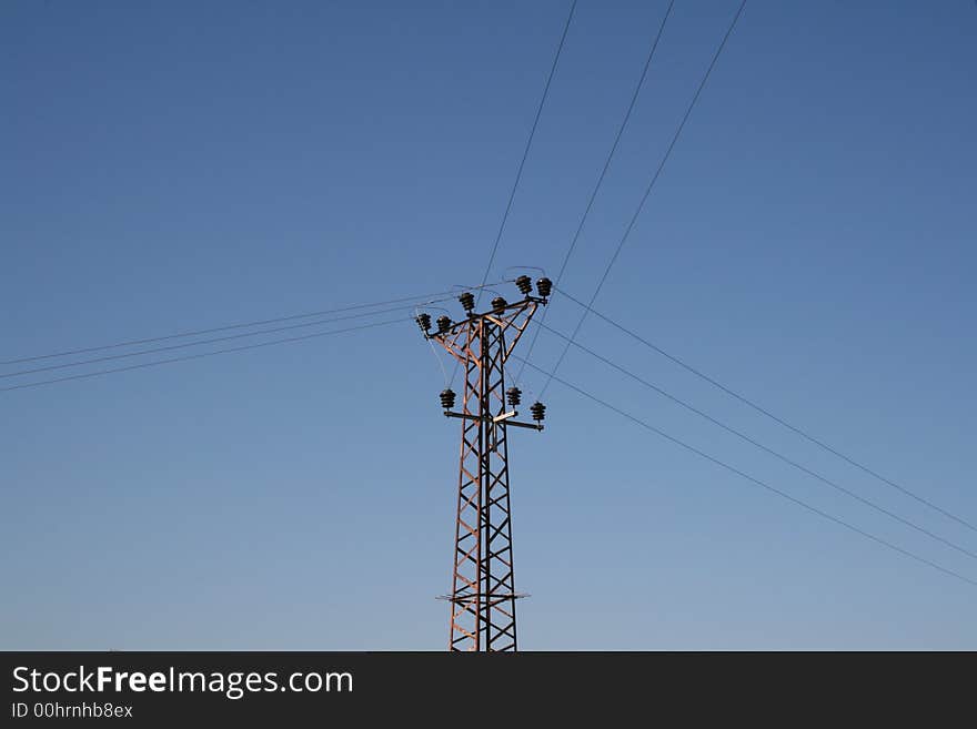 Power lines goes to three sides with blue sky background. Power lines goes to three sides with blue sky background