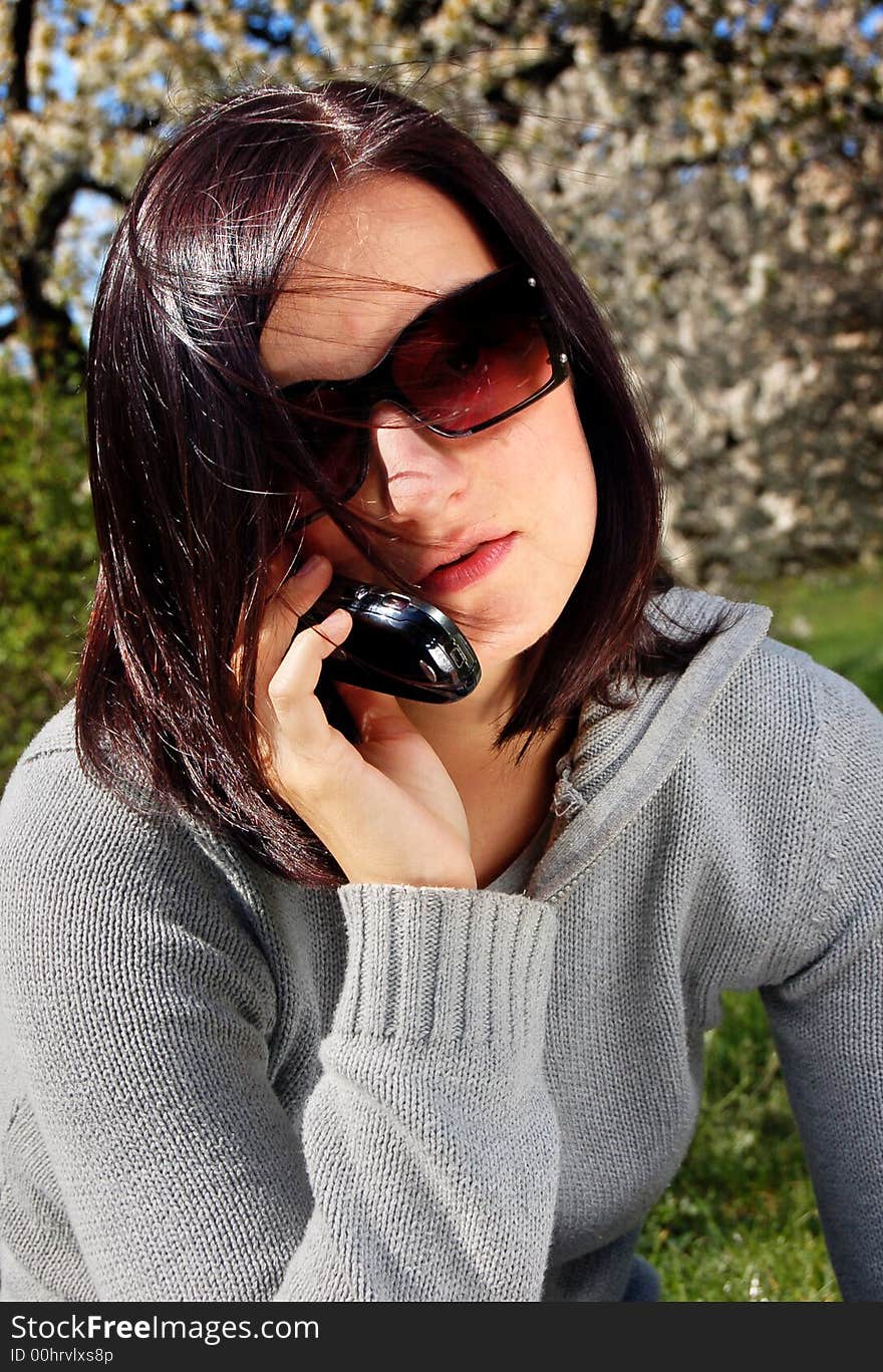 Portrait of a brunette nice girl in a park.