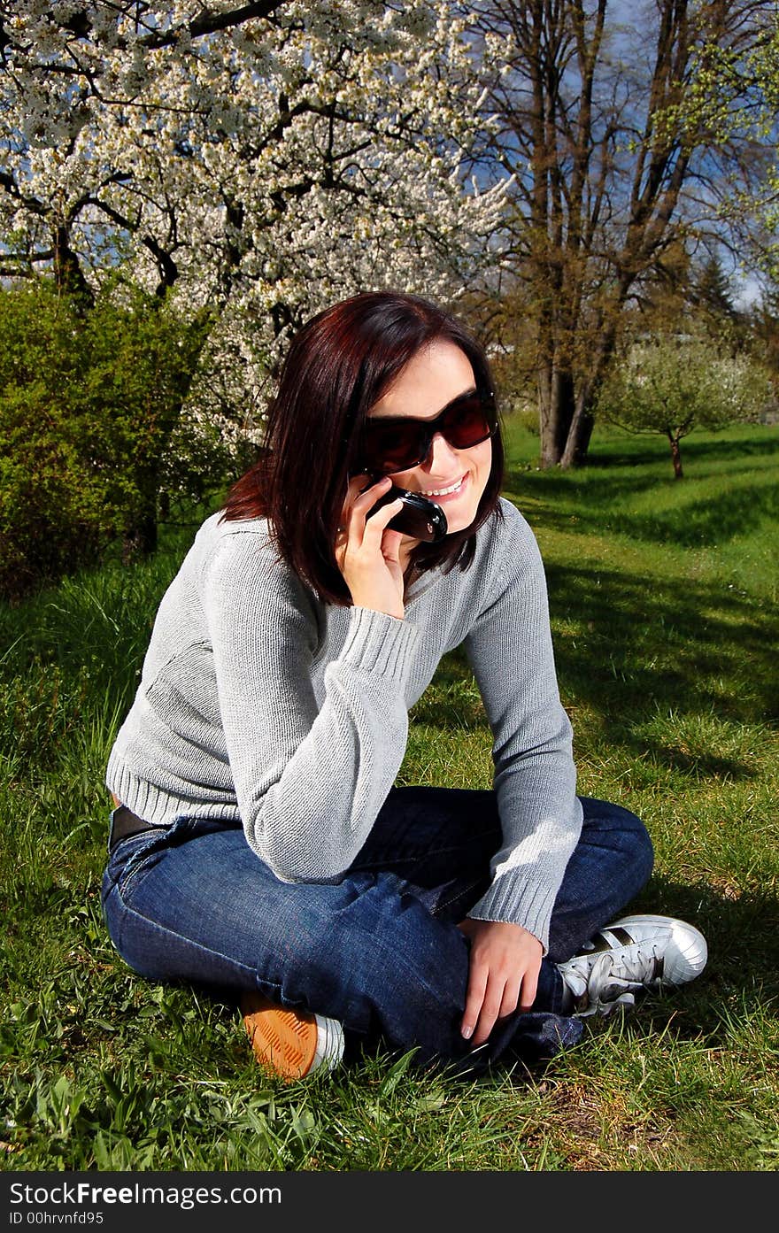 Portrait of a brunette nice girl in a park.