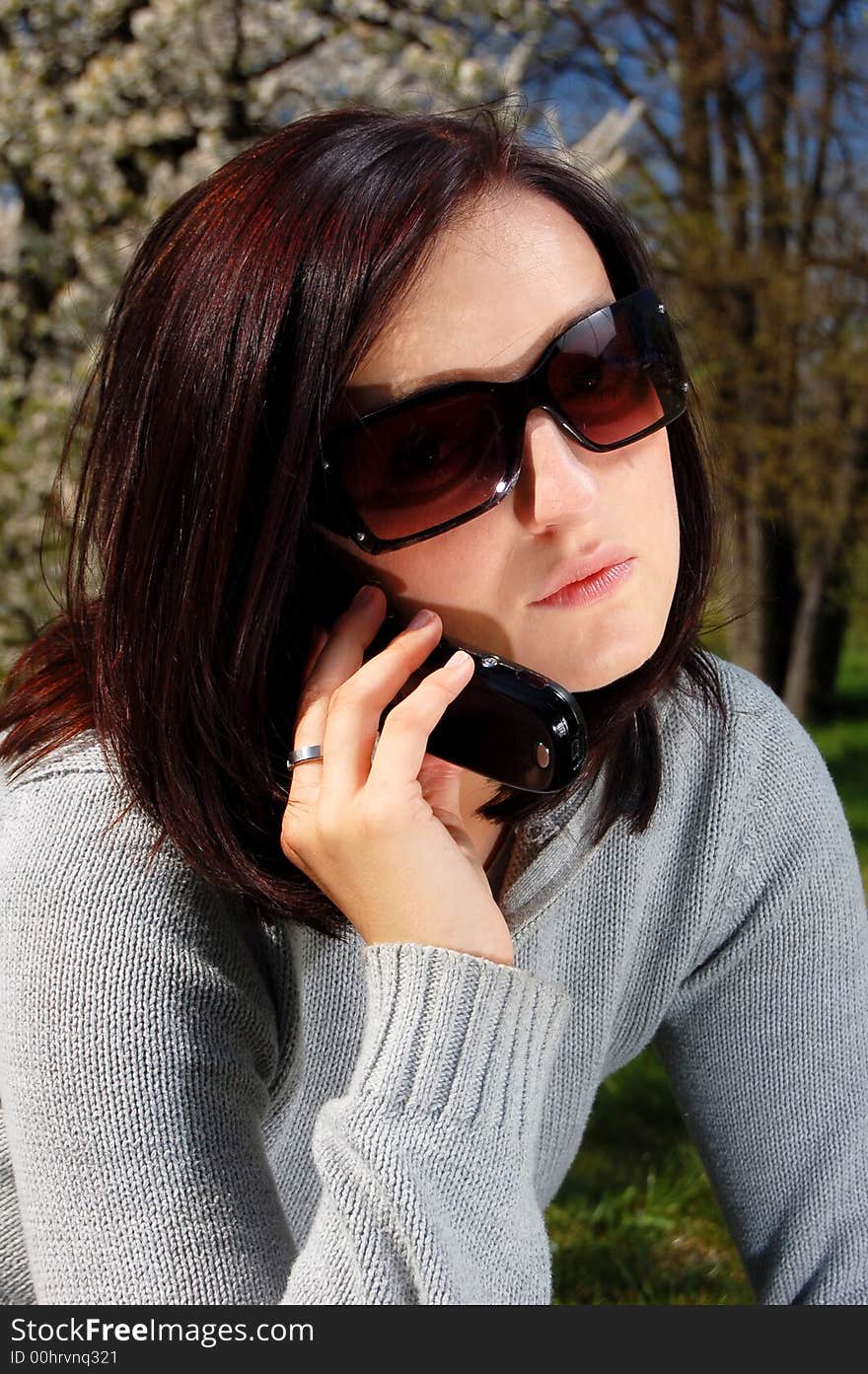 Portrait of a brunette nice girl in a park.