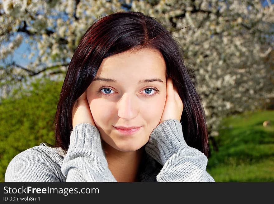 Portrait of a brunette nice girl in a park.