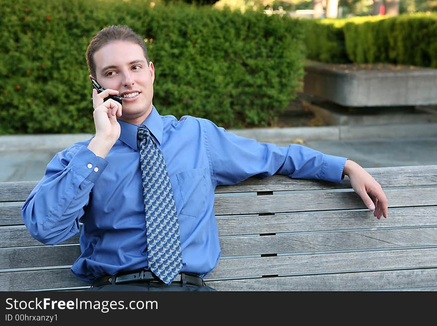 A handsome business man talking on a cell phone