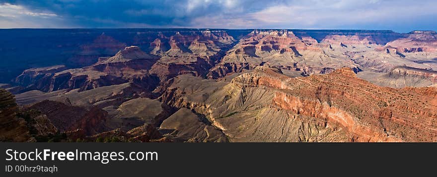 Panorama view of Grand Canyon late evening, storm clouds and shadows. Panorama view of Grand Canyon late evening, storm clouds and shadows