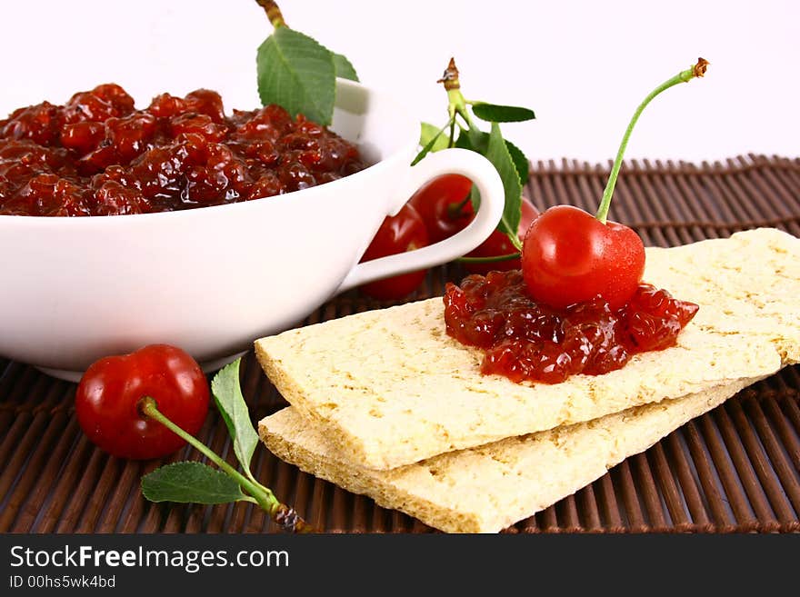 Red cherry jam isolated on white -brown. Red cherry jam isolated on white -brown