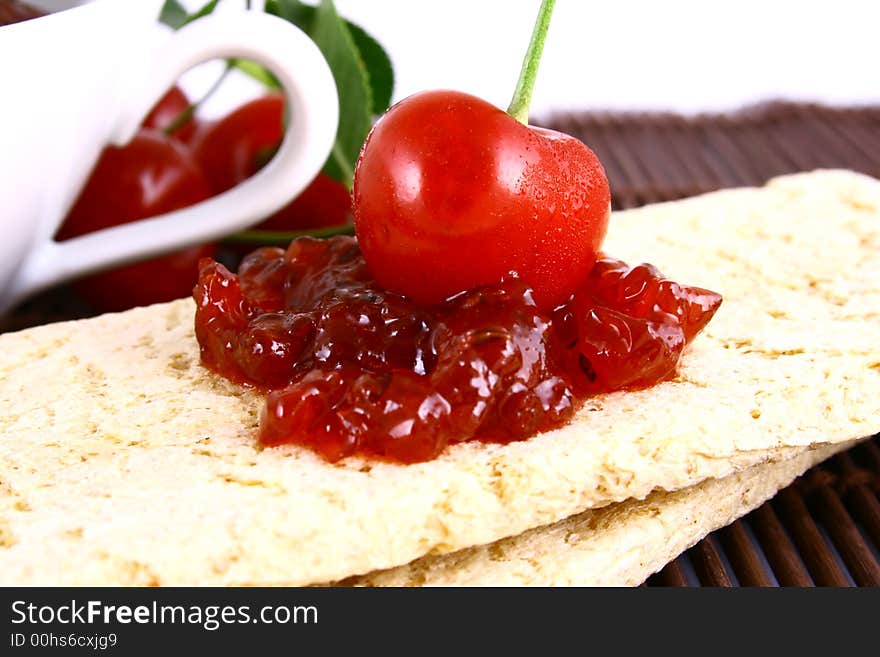 Red cherry jam isolated on white -brown. Red cherry jam isolated on white -brown