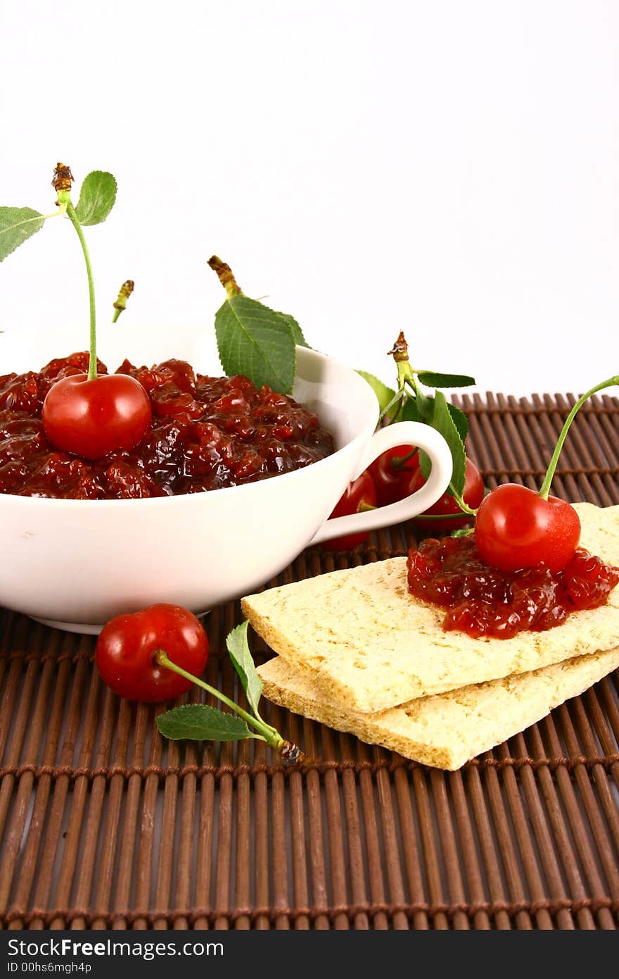 Red cherry jam isolated on white -brown. Red cherry jam isolated on white -brown