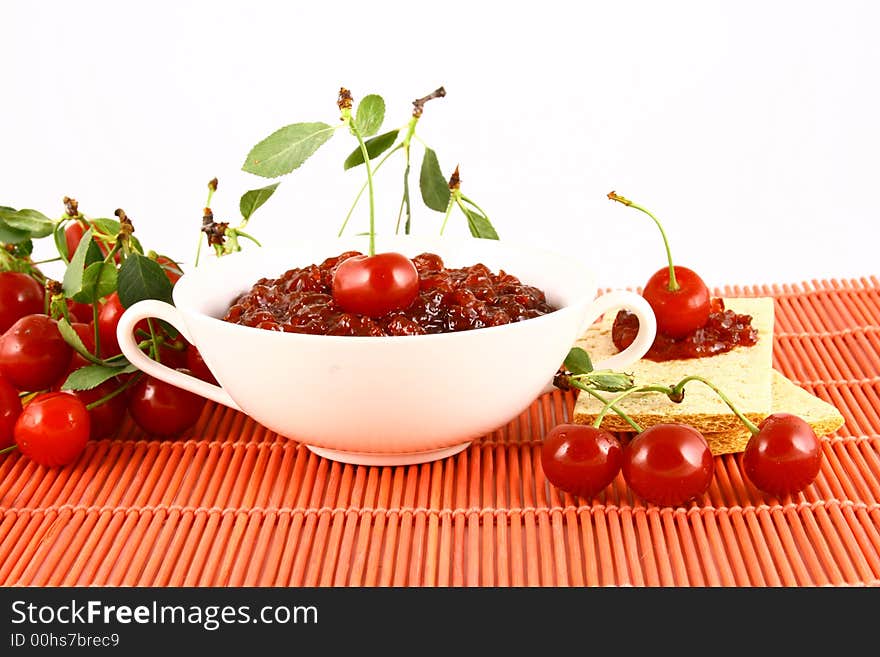 Red cherry jam isolated on white -brown. Red cherry jam isolated on white -brown