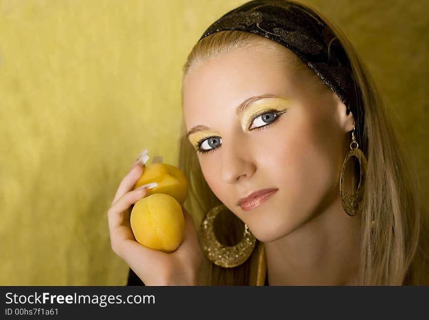 Portrait of young beautiful blond girl with apricot