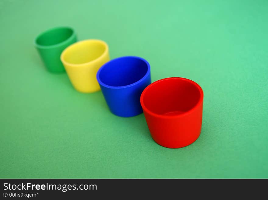 Four colored mug,
blue,green,red,yellow,

selective focus,. Four colored mug,
blue,green,red,yellow,

selective focus,