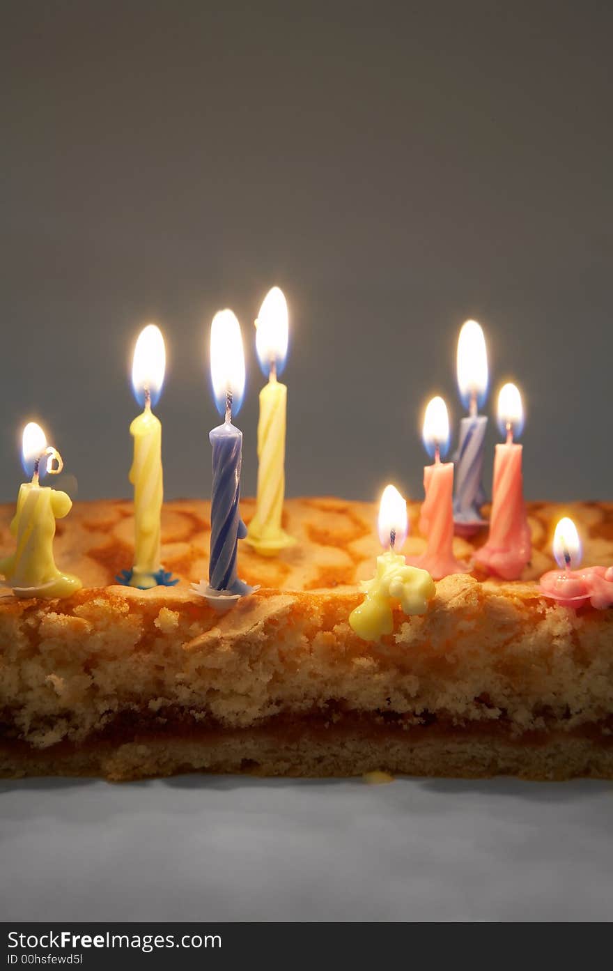 Burning color candles on a celebratory pie