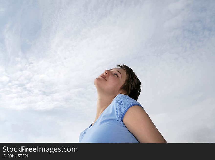 Happy girl on the sky background in summer. Happy girl on the sky background in summer