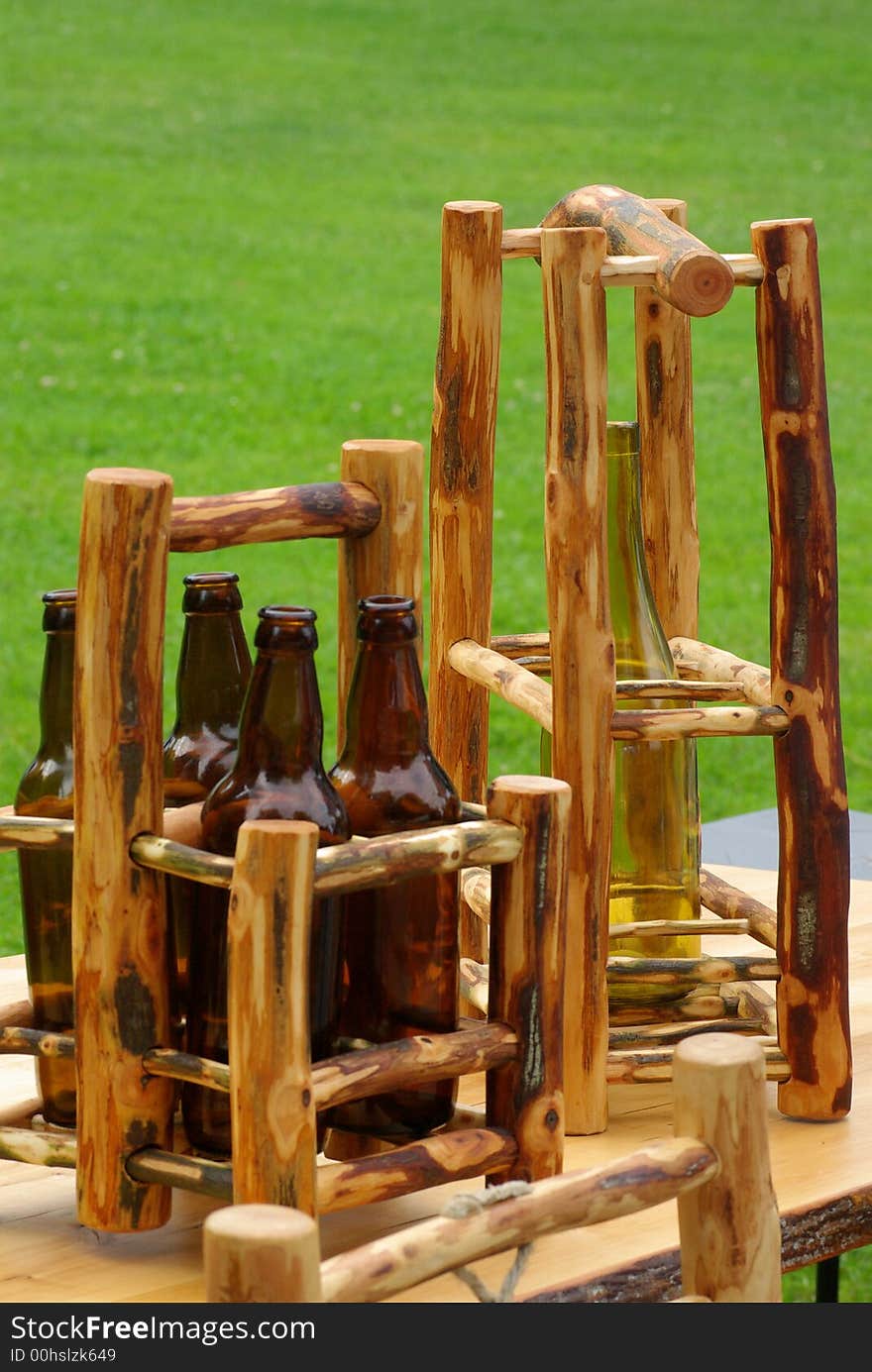 Beer and wine bottles standing in two wooden holders. Beer and wine bottles standing in two wooden holders