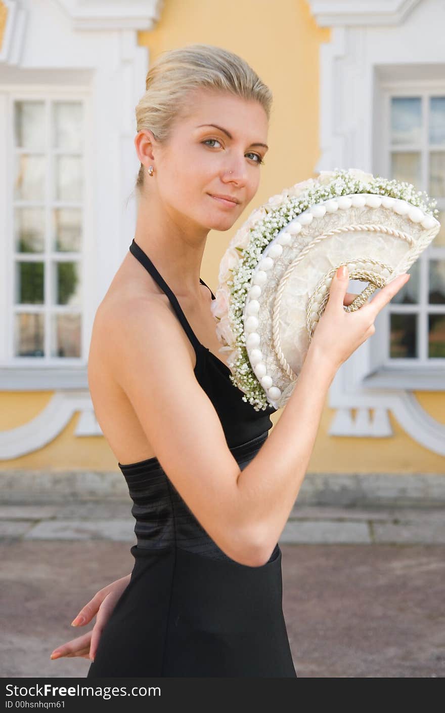 Beautiful blond girl with a bouquet of white roses