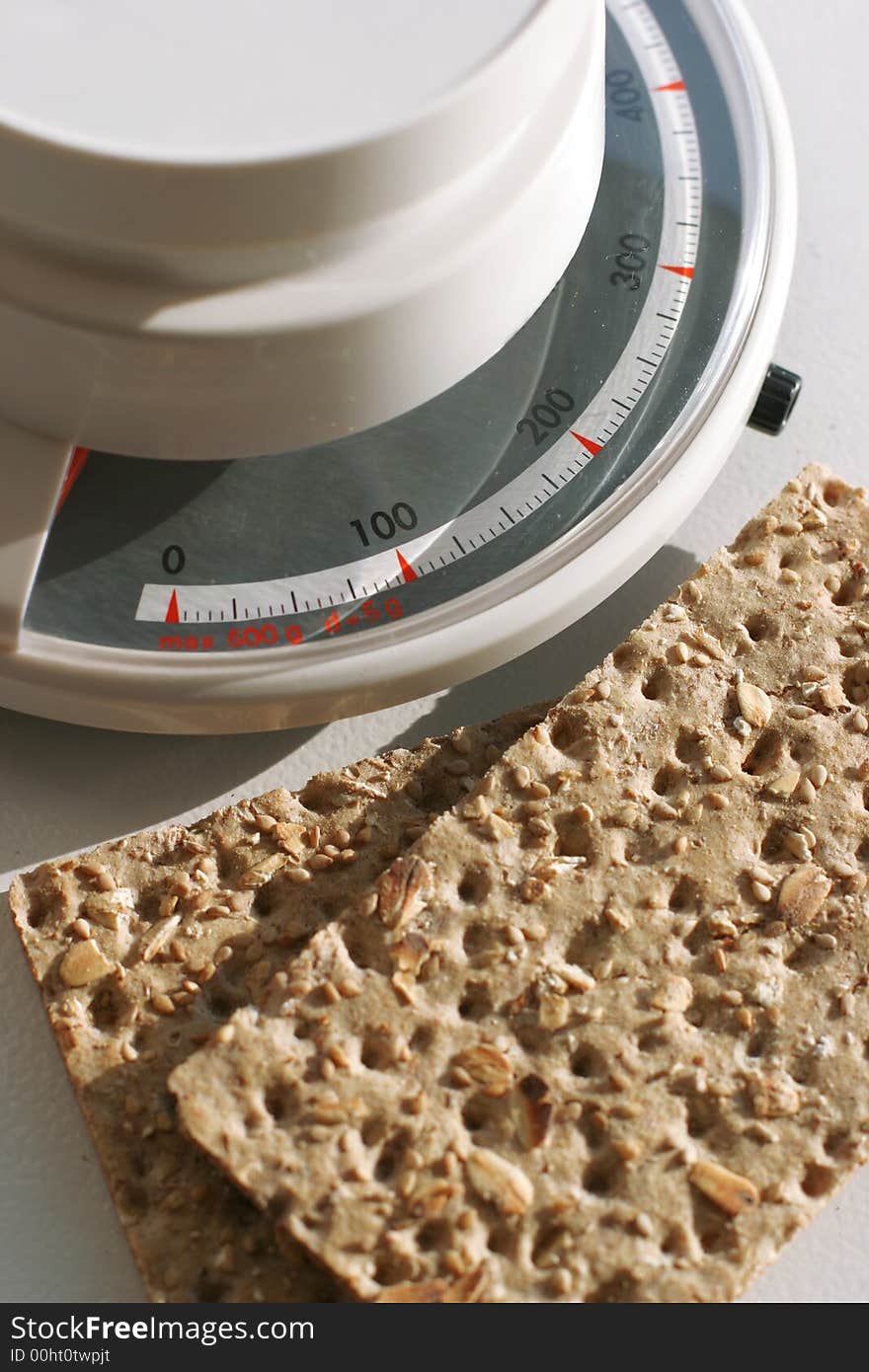 Dry crackers and a food scale. Dry crackers and a food scale