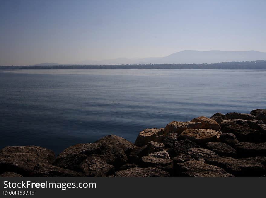 Serene Lake with Rocks and Blue Sky. Serene Lake with Rocks and Blue Sky