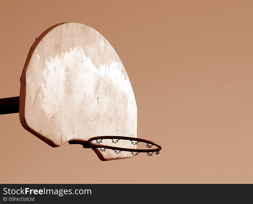 A playground basketball hoop shot in sepia. A playground basketball hoop shot in sepia.