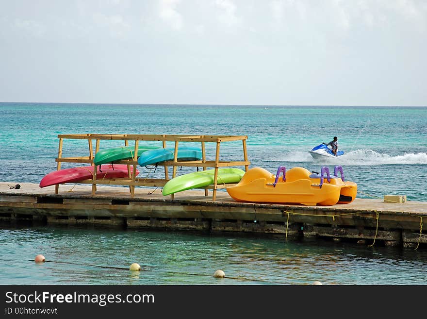 Colorful kayaks hanging to dry