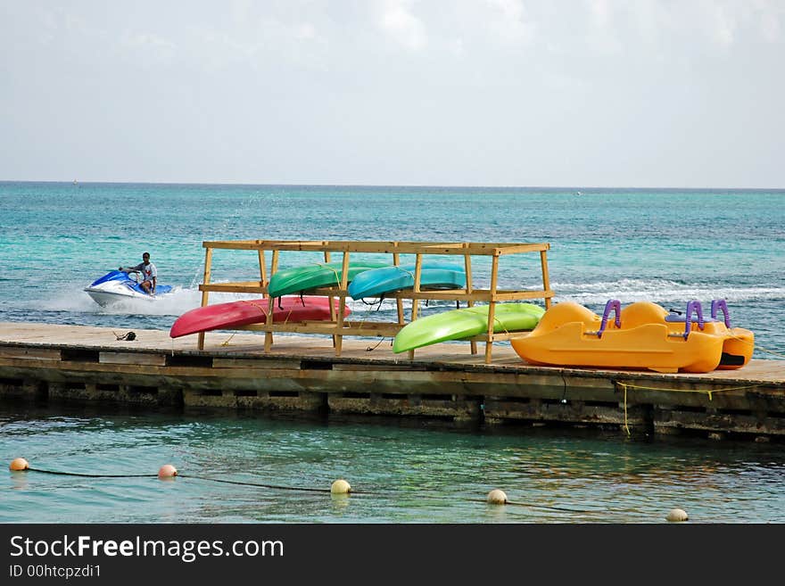 Colorful kayaks hanging to dry. Colorful kayaks hanging to dry