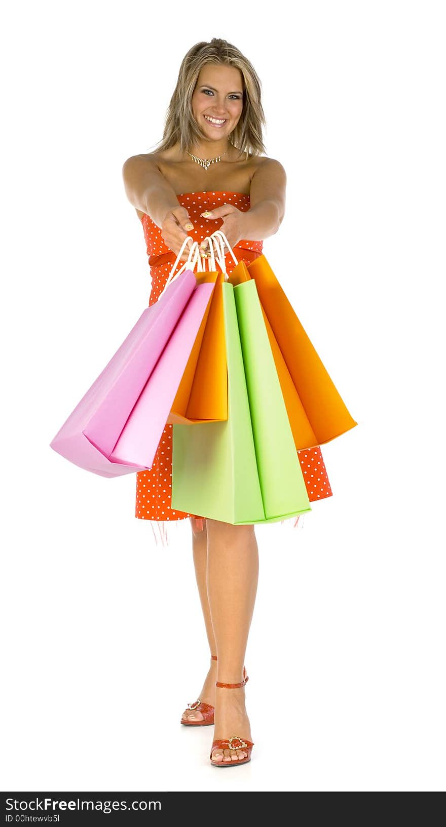 Beautiful, young woman standing and holding bags. Woman is giving bags to somebody. Isolated on white in studio. Looking at camera, hole body. Beautiful, young woman standing and holding bags. Woman is giving bags to somebody. Isolated on white in studio. Looking at camera, hole body