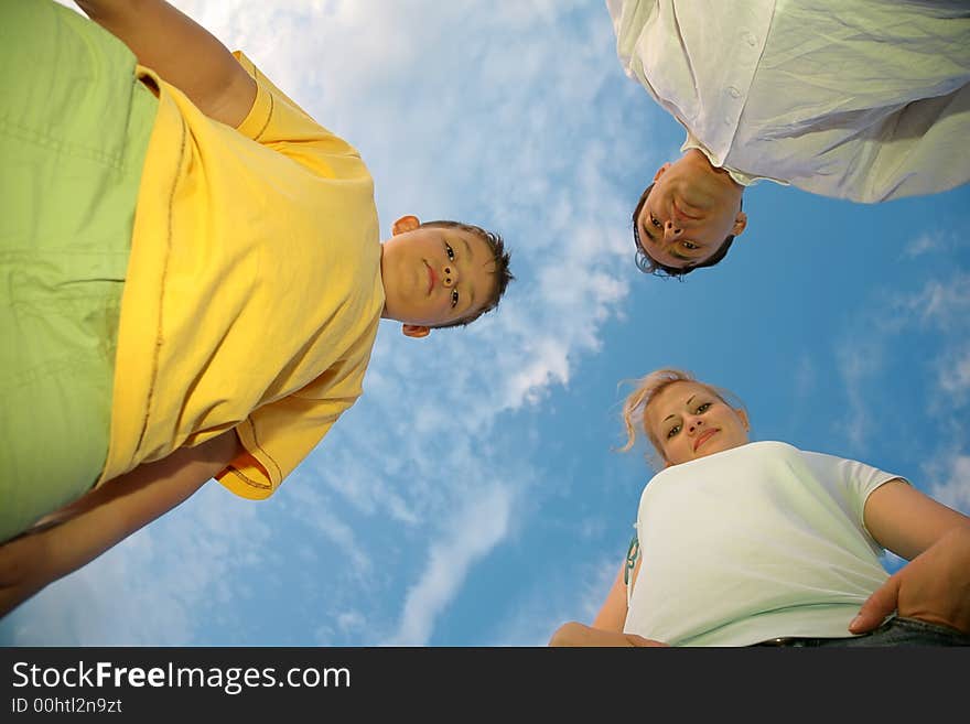 Child with the parents against the background of the sky. Child with the parents against the background of the sky