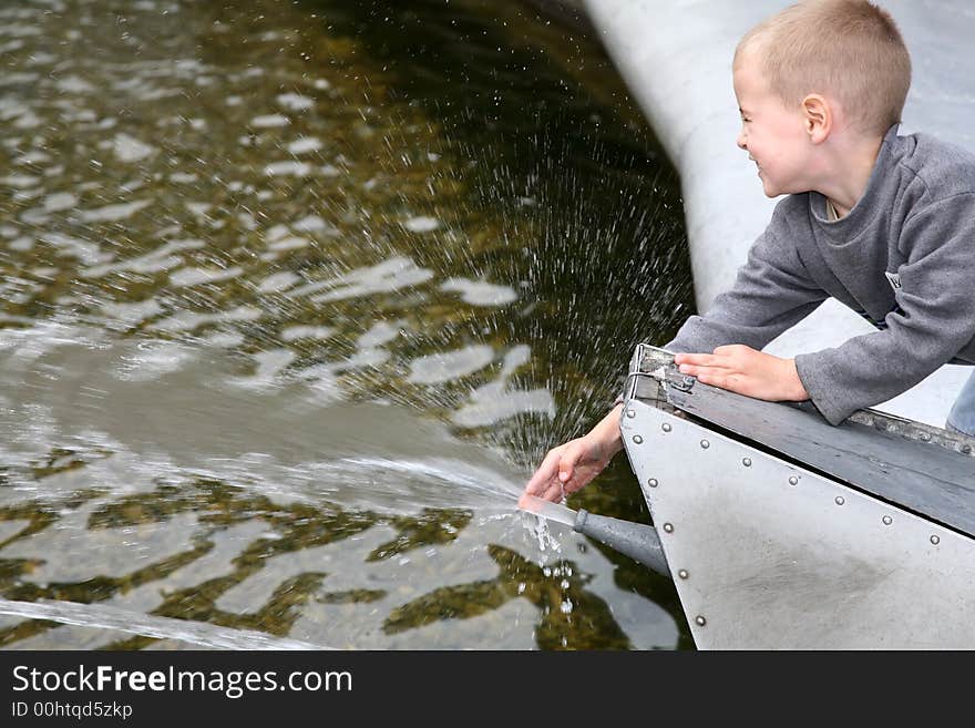 Child near the fountain played with water