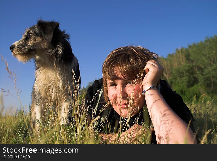 Young woman with dog on meadow