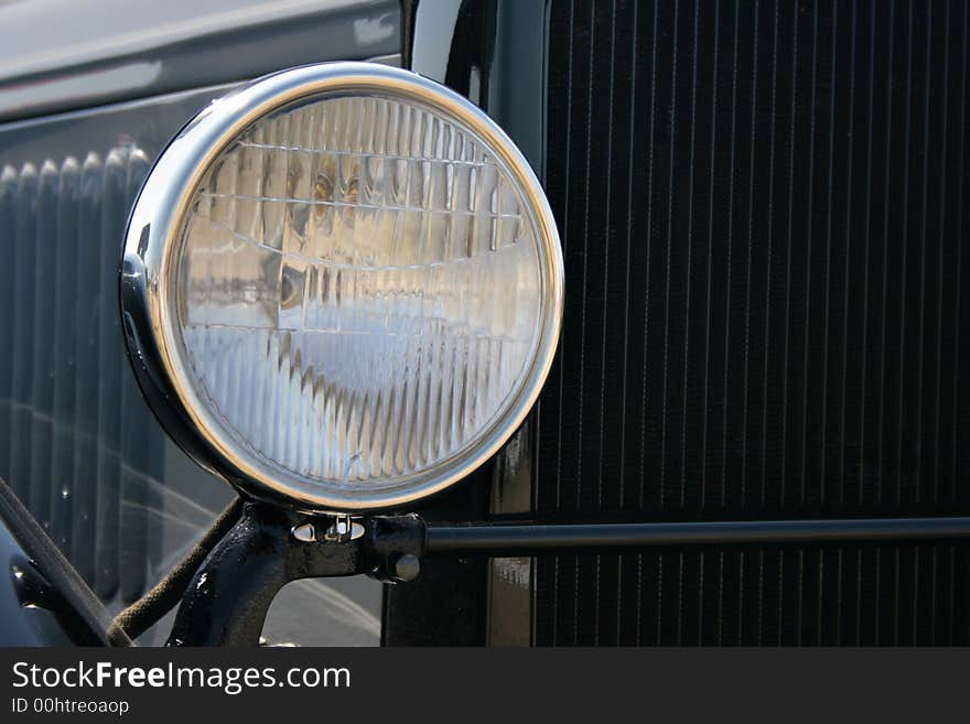 Headlight of black retro car close-up