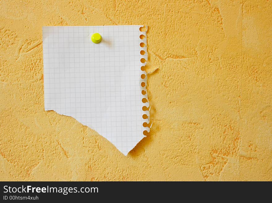 Lacerated blank sheet attached to a yellow wall