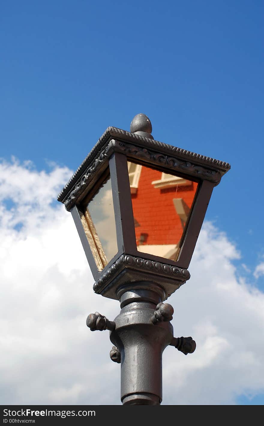 Street lamp with building reflection