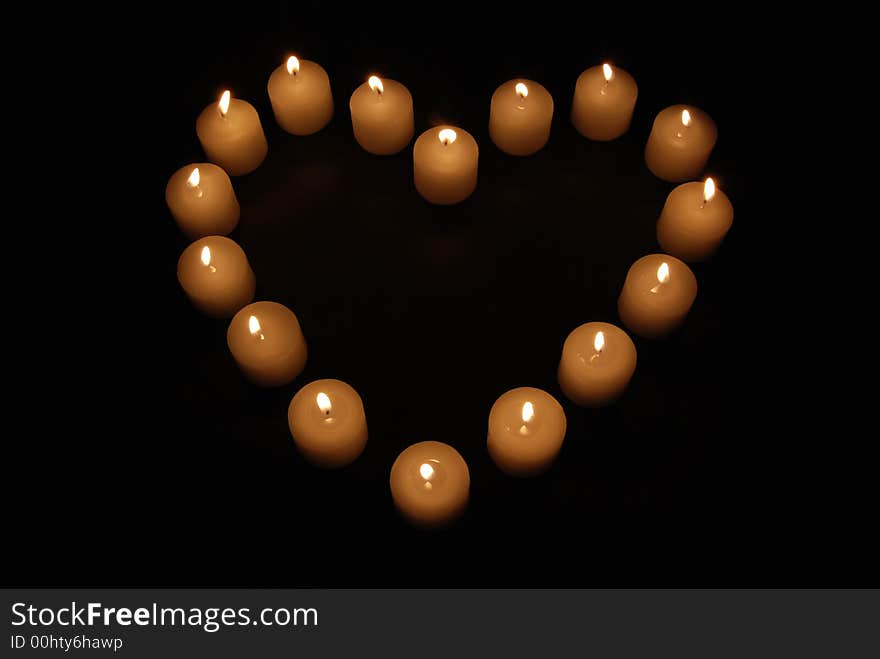 Lit candles in the shape of a heart