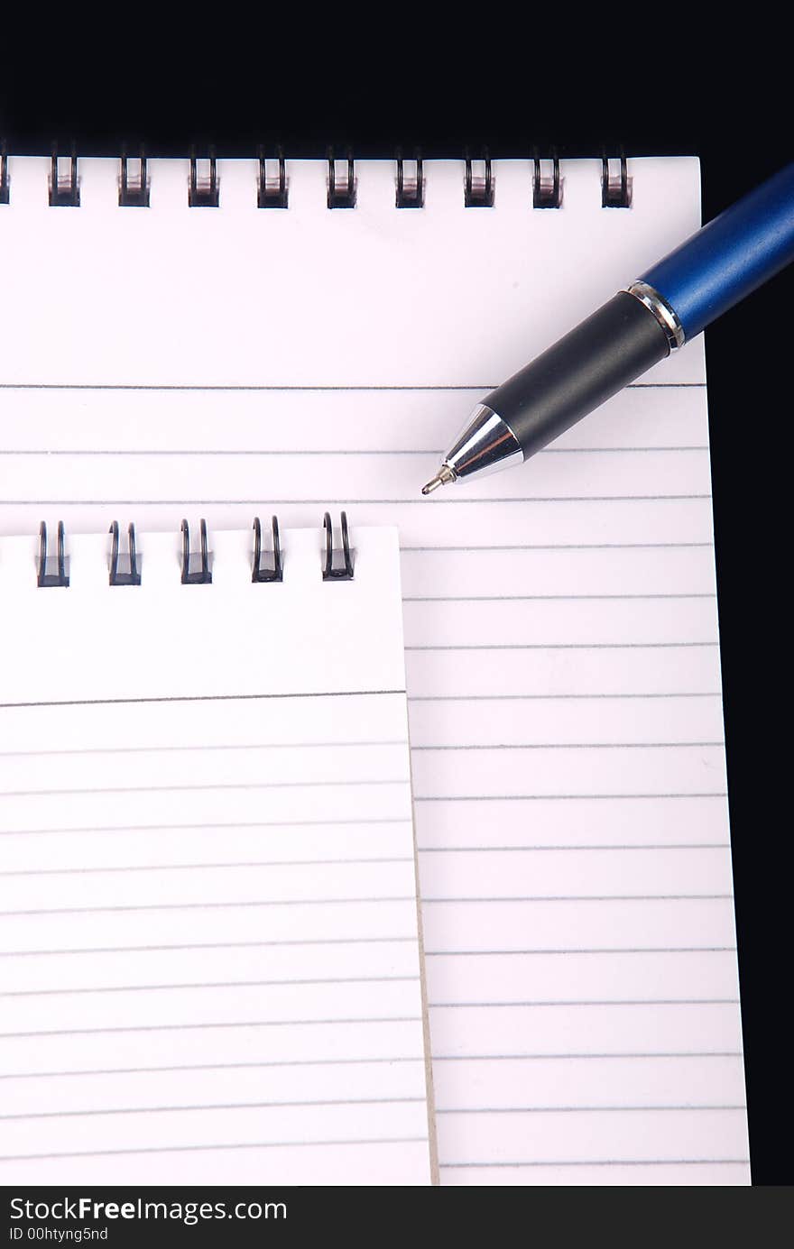 Writing notebook with pen on white background. Writing notebook with pen on white background