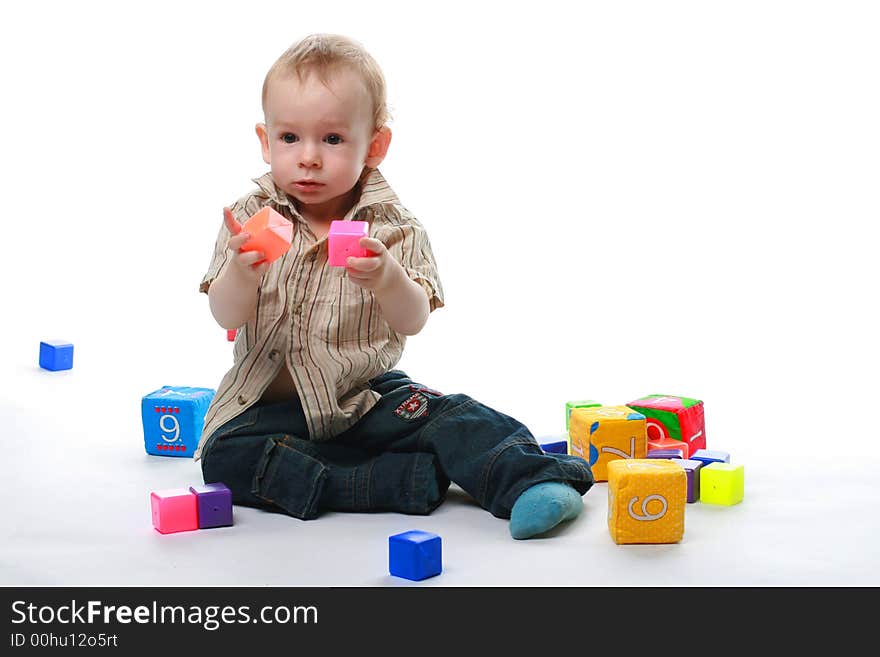 Baby plays cubes on a white background. Baby plays cubes on a white background