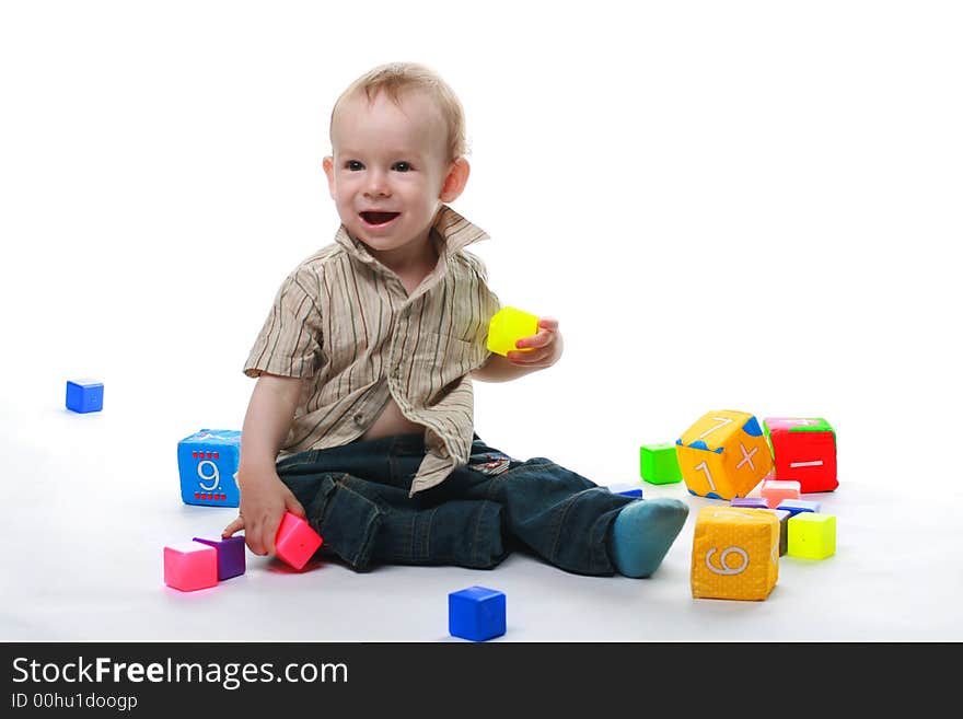 Baby plays cubes on a white background. Baby plays cubes on a white background