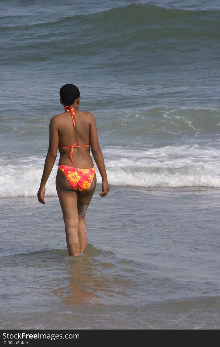 Pretty figured black woman going for a swim at the beach. Pretty figured black woman going for a swim at the beach